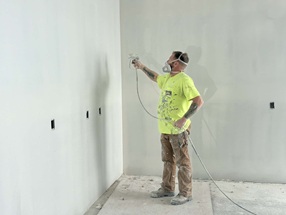 Spraying new walls with primer
