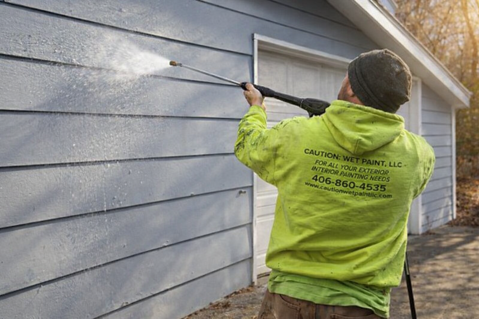 Pressure washing house before painting